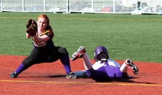Elsa Moyer dives back to the bag during the Lake Washington and Issaquah game on Wednesday.