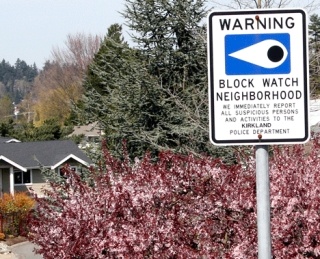 A Block Watch sign in the Houghton neighborhood warns suspicious persons they will be reported. The home of Rocio Vela Fuentes and husband