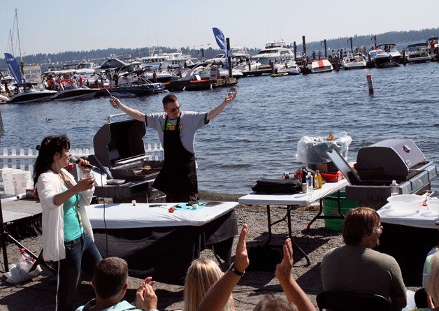 The crowd cheers on the MOVin 92.5 chefs during a grill off at the Kirkland Uncorked event at Marina Park Sunday.