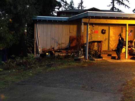 Kirkland resident Joey Ladson talks on the phone in the front yard of his house