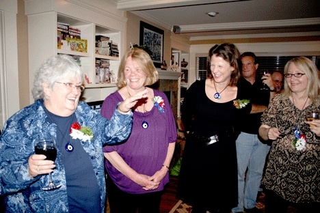 Kirkland City Council candidate Doreen Marchione (left) holds up her glass for a toast while candidates Penny Sweet