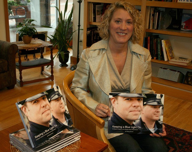 Stacey Sanner sits in Parkplace Books where she will sign her new book for patrons on Nov. 30. Her book pays tribute to Seattle Police officers.