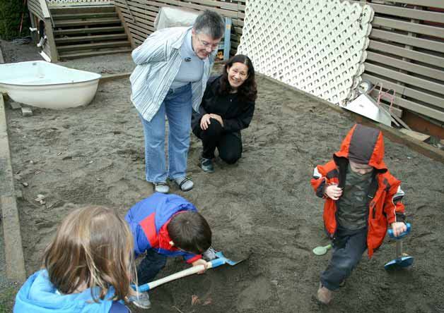 Youth dig up dinosaur 'bones' in the sandbox at Kirkland Preschool Monday