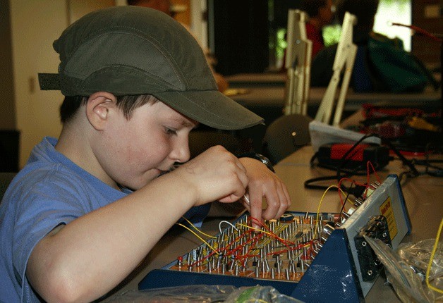 Mitchell builds a circuit with an electronic kit during a Lake Washington Ham Club meeting on Saturday. The club member has his own radio operating license.