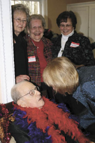 Chuck Morgan gets a farewell peck during festivities Sunday at Heritage Hall. (Below) Kirkland Deputy Mayor Joan McBride  applauds the man of the hour. KENDALL WATSON