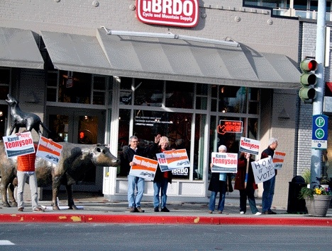 Kirkland City Councilmember Tom Hodgson (center) and council candidate Karen Tennyson (third from left) and supporters wave campaign signs on Central Way Friday.