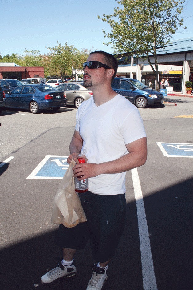 Shaun Hanning stands outside of the Parkplace QFC in Kirkland on Monday. He says he is opposed to the city of Kirkland banning plastic shopping bags.