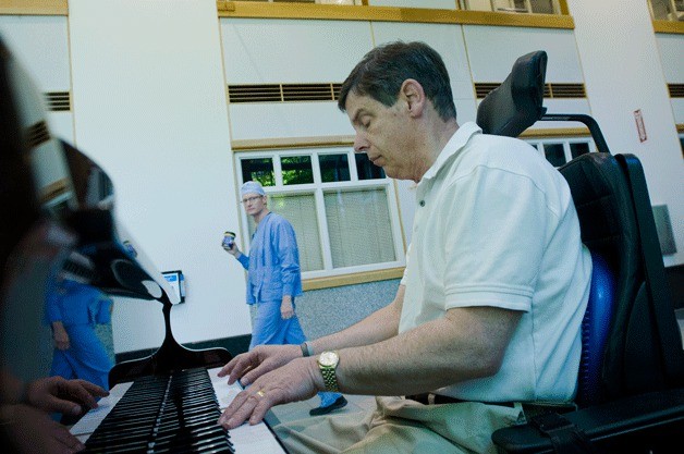 Volunteer Rick Hoover plays the piano in the Galleria at Evergreen Hospital May 18. Hoover