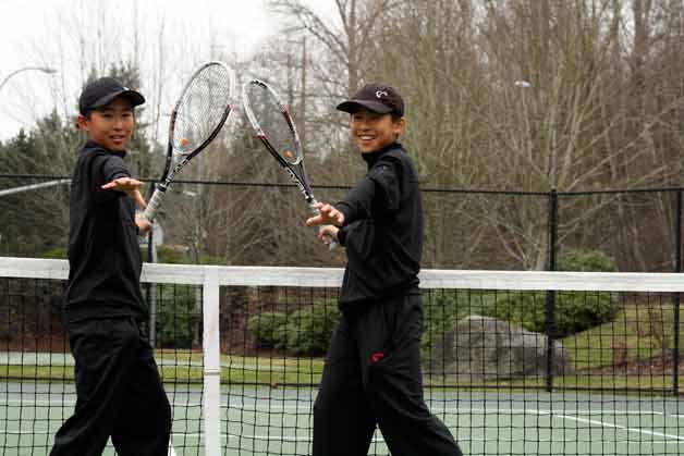 Thomas and Hames Yu train with Kirkland tennis coach Dan Willman.