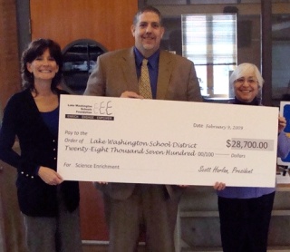 Lake Washington School District Superintendent Dr. Chip Kimball and other district members hold up a check awarded by the Lake Washington Schools Foundation.