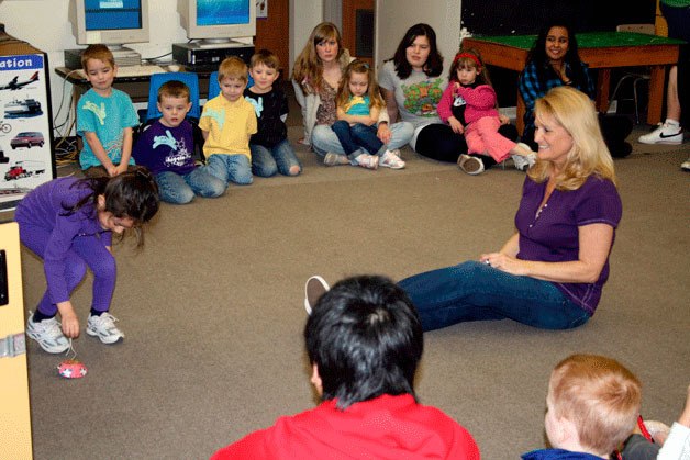 Vicki Bundy sits in the middle of her classroom during show and tell with the “Little Roos” at Lake Washington High School on Tuesday.