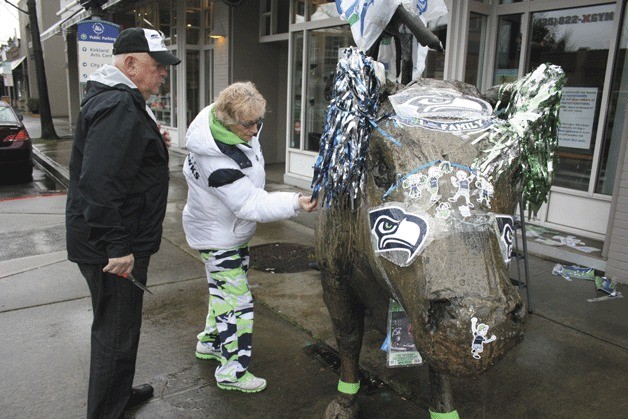 Santos Contreras and Terri Fletcher decorate the Cow and Coyote for the Seahawks Super Bowl game back in January.