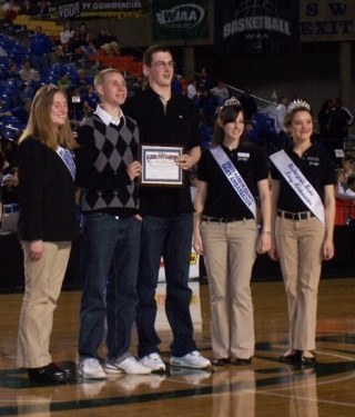 Kangs boys basketball players Preston Fawcett (2nd from left) and Greyson Blue (center) are honored at the Tacoma Dome. The pair are attended to by Washington State Dairy Ambassadors alternate Michelle Wesen