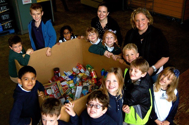 Ellie Sivesind  stands with her second grade class from Evergreen Academy at Hopelink. Sivesind helped organize the donation of 1