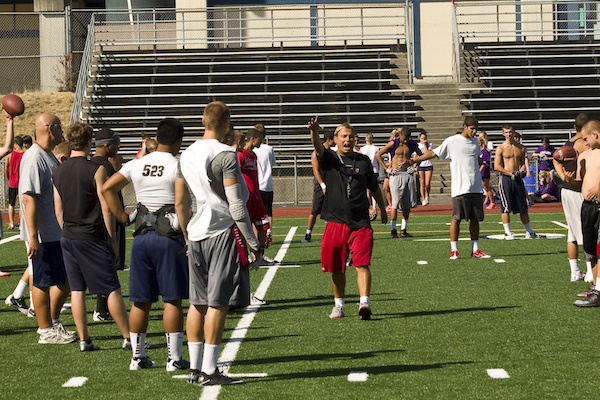 Juanita High head football coach Shaun Tarantola goes over a play with his team at a recent practice at the school. The Rebels defeated 4A Inglemoor in a nonleague contest to open up their season last Friday