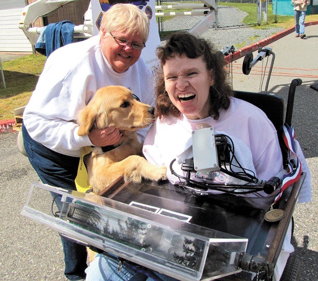 Tania Finlayson is greeted by a guide dog puppy-in-training at the 2012 Flight for Sight fun run. Finlayson