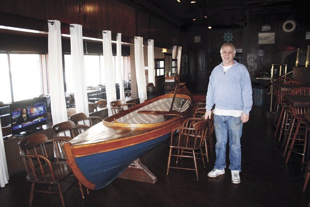 Todd Jones stands at the new location of Todd's Crab Cracker near a boat that will become a table when the store opens. Regulars of the Crab Cracker may recognize the boat