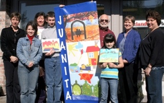 Proud Juanita residents hold up their new banner