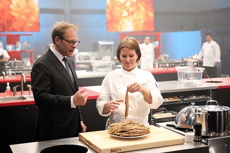 Cafe Juanita owner and chef Holly Smith competed on two episodes of Iron Chef in 2009. Host and Food Network personality Alton Brown looks on.
