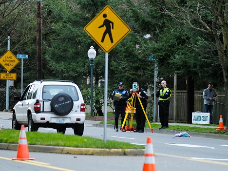 Kirkland police work an accident scene on Wednesday where a teenage girl and her toddler sister were hit by an SUV in a crosswalk. The two girls were transported to Harborview Medical Center.