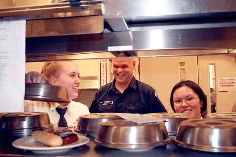 Kirkland Reserve Firefighter Patrick Coor helps out servers Arianna Ayers
