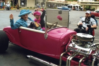 Lake Vue resident Peter Becker (right) admires a hot pink Model P Ford Roadster at last year's car show. Car owner Sarah Starr (behind the wheel) and her mother are also pictured.