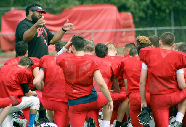 New Juanita High School head football coach Lele Te’o addresses his team following a recent preseason workout.