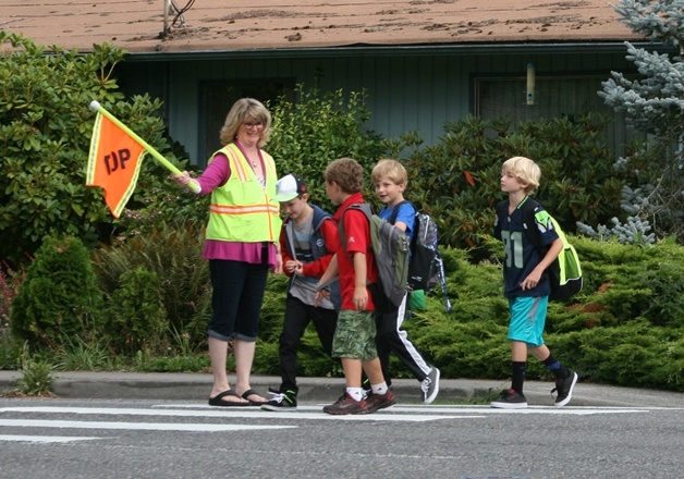 Kids walk to school for the first day of classes in Kirkland on Tuesday.