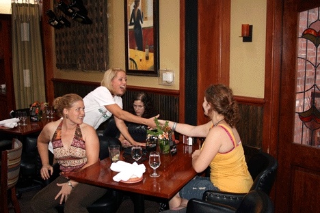 Kirkland mom and winner of The Next Food Network Star Melissa d'Arabian (center) shakes hands with locals at Hector's Restaurant recently. Also pictured is Lisa Nelson