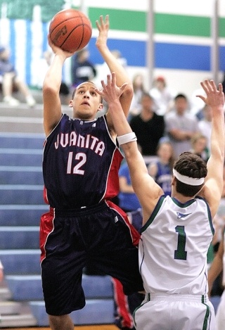 Juanita’s Cole Graves puts up a shot past Liberty’s Turner Chatterton last Tuesday at Liberty.