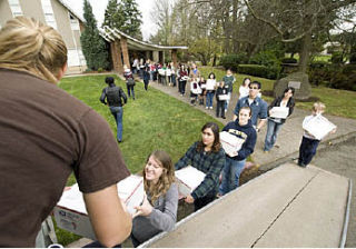 Northwest University students form a line from Butterfield Chapel to the trailers with the boxes they had packed to send to Iraq.