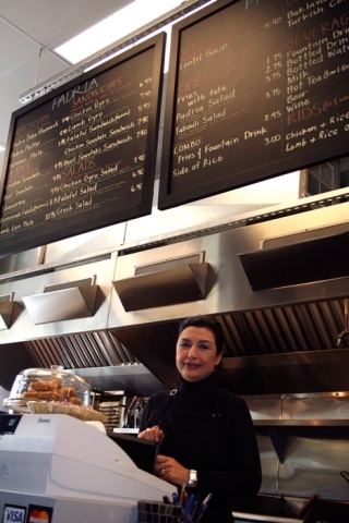 Shahin Shahidy tends the counter at her new resturant in the Juanita Village called Padria Mediterranean Cafe.