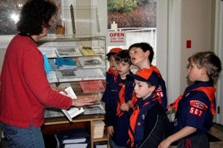 Kirkland Heritage Society archivist Loita Hawkinson gives Cub Scout Troop 567 a little history lesson. Cub Scouts (left to right) Xander Fries