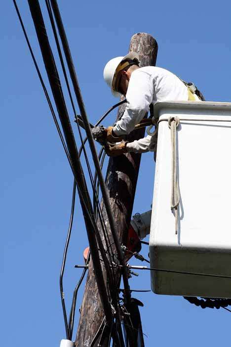 Paul Turner of Potelco performs maintenance on a utility pole for Puget Sound Energy. The Kirkland City Council pushed back a planned vote to put a measure on the November ballot to raise the utility tax from 6 to 7.5 percent.