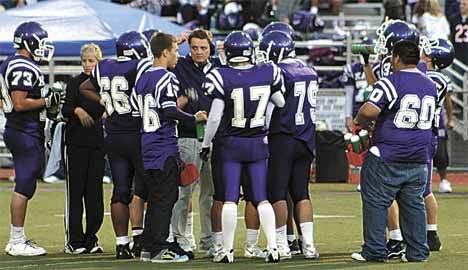 Members of the Lake Washington football team plan out their strategy during a time out. The Kangs lost to Mercer Island 14-7 despite shutting down the Islanders’ high-powered offense.
