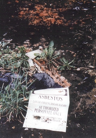An asbestos sign at the former Pace site warns of potential health hazards.