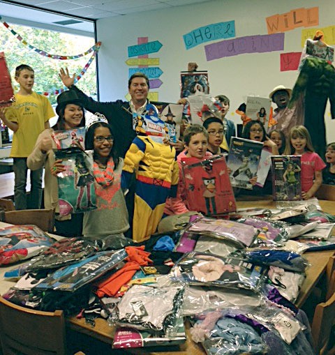 Jim Walen and Kristen Howard of Ford of Kirkland kickoff the countdown to Halloween by delivering more than 60 costumes to the Boys & Girls Club of King County's Kirkland branch.