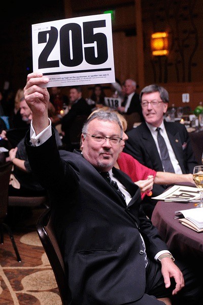 Gunnar Nordstrom makes a bid during the Kirkland Performance Center’s “An Affair for the Arts” benefit at the Hyatt Regency Bellevue on Oct. 30. The event raised $185