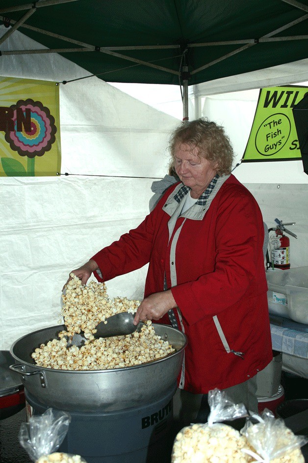 Joann Green of Classic Kettle Corn prepares some popcorn during opening day of the Kirkland Wednesday Market on Park Lane Wednesday.