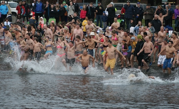 Hundreds of participants take a trip into the frigid waters of Lake Washington on New Years' Day in Kirkland.