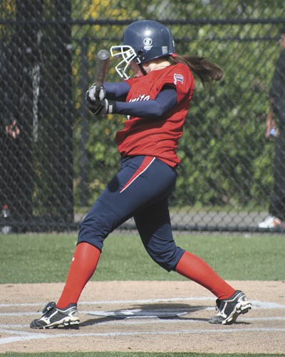 Juanita's Kellie Shinstrom swings during the first inning of the Rebels district softball game against Chief Sealth. Juanita won the game 12-0 in five innings.
