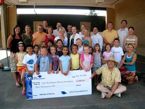 Students at the Summer Literacy Camp proudly display a check for $3