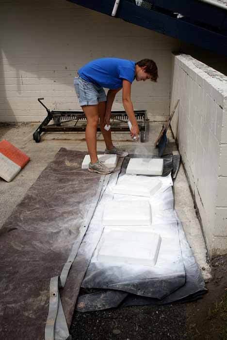 Kirkland Parks and Rec. employee Molly Enger spray paints bases in preparation for the 2009 Junior Softball World Series to be played at Everest Park in Kirkland August 16-22.