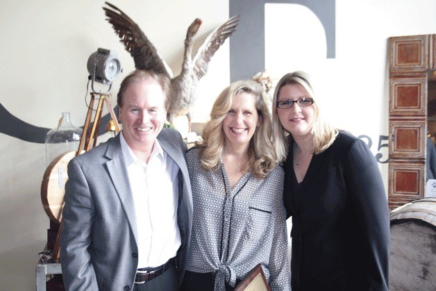 Greater Kirkland Chamber of Commerce Director Bruce Wynn (left) and Chamber Business and Communications Manager Samantha St. John (right) organized a 'cash mob' for Common Folk Co. business owner (middle) on Feb. 20 after learning her house was damaged in a recent fire.