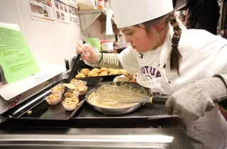 Sarah Leslie drizzles an icing on to her receipe of Carmel Apple Biscuits during the 2nd Annual LWSD Kids Can Cook Culinary Competition at Redmond Junior High School on Wed.