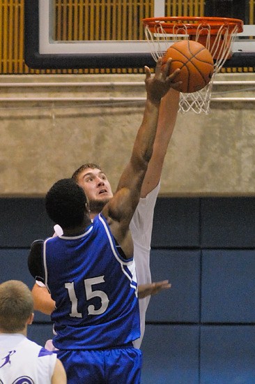 Lake Washington center Darien Neslon-Henry blocks a shot attempt by Seattle Prep guard DJ Fenner (15) in the first quarter of a SeaKing district tournament game at Bellevue College on Thursday.