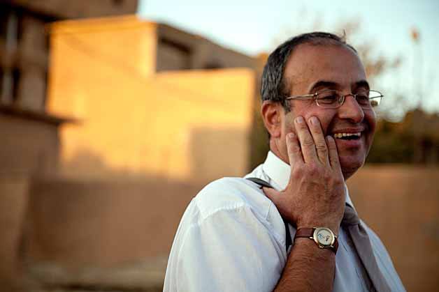 Former Kirkland resident Sam Malkandi outside the former prison of Saddam Hussein in Iraq. Below: Seattle filmmakers and journalists Alex Stonehill and Sarah Stuteville interview Malkandi at his home in Iraq last November.