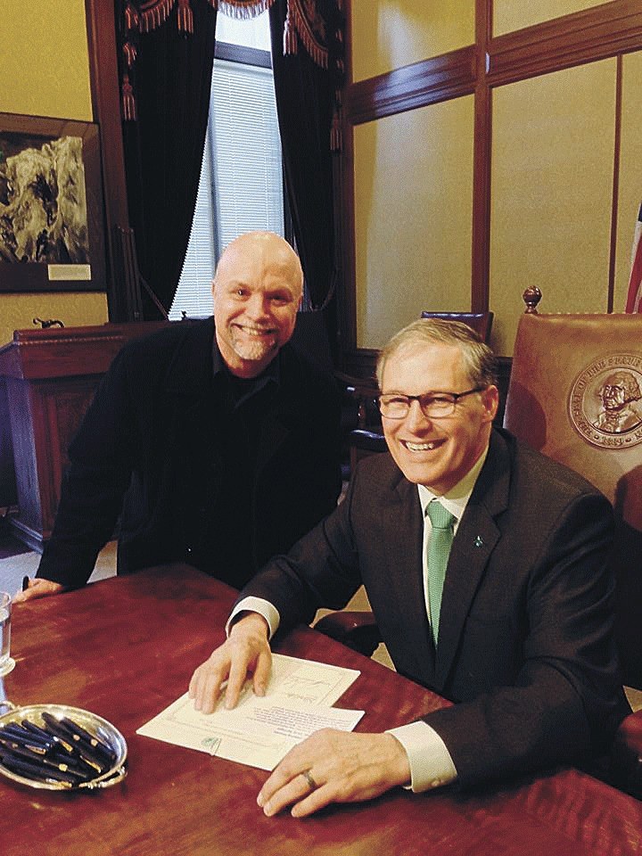 John Bagge and Gov. Jay Inslee in Olympia as Inslee signs House Bill 2680 into Washington law on March 17.