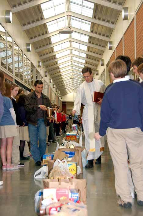 Lou Lucarelli and Father Kurt Nagel bless the food given to Holy Family’s St Vincent de Paul Conference. Lucarelli is the Vice President of St Vincent de Paul. All of the recipients of the donated food reside within Holy Family’s parish boundary.  There are four other St Vincent Conferences servicing Kirkland and Bellevue including Sacred Heart Bellevue