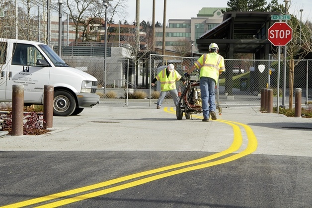A striping crew applies the finishing touches Feb. 26 to Park Lane’s center median near the transit center on Third Street. The two-man crew repainted 14 angular parking stalls as well.